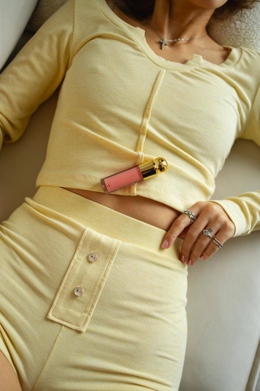 Close-up of the Butter Cream rib knit fabric on the Velloria Lumi Lounge Set highlighting the soft texture and button details.